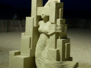 This image isn't quite as clear as I'd hoped, but I think it kind of works. The sculpture is a woman growing out of the confines of a modern city-like skyscraper; the blurriness of my photography adds movement. Without it, she might just be a static sand-doll trapped and not breaking free.